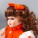 Doll Collectible Ceramics "Agatha in a bright orange dress and banta, with ruffles" 30 cm