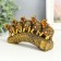 Polystone souvenir "Five elephants on a tusk with flowers" bronze 17x4x8 cm