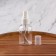 A bottle for storage, with a spray, with a division scale, 50 ml, white/transparent color