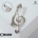 Brooch "Violin key" radiance, white color in silver