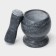 A mortar with an “marble” push, made of natural stone