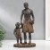 Polystone souvenir "African with son" under a tree 32x15.5x9 cm