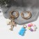 Earrings with the removable element "Transformer" Bear and heart, colored in gold