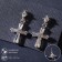 Earrings with rhinestones “Spark crosses” with a putty, white color in silver