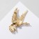 Brooch "Bird" in flight, black color in gold