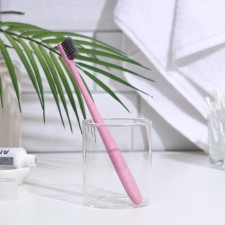 The toothbrush is soft, in the tube, pink