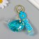 A plastic keychain with a carbine, a whale strap of water with sparkles 4x7x2.5 cm