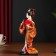Collectible doll "Geisha in an orange kimono with a fan" 22.5 cm