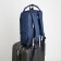 A backpack of textiles with a zipper, 3 pockets, a laptop, blue color