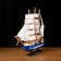 The ship souvenir medium "Spanola", the sides of white and blue, white sails, 43x39 x 9 cm