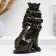 The piggy bank "Leo with a crown and a ball sits" black with gilding, 23cm