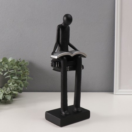 Souvenir Polystone "Abstraction. A person sits on books reads" Black with silver 7.5x11x30cm