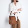 Women's backpack made of artificial leather with lightning, 4 pockets, brown color