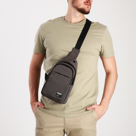 Male sling bag from textiles, headphone opening, gray color