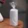 Candle-cylinder with faces, 5x10 cm, gray, 6 hours
