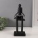 Souvenir Polystone "Abstraction. A person sits on books reads" Black with silver 7.5x11x30cm