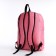 A backpack with a zipper, external pocket, pink color