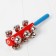A rattle with bells and a handle, the color of mix