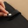 The fastener is sewn for a bag, on a button, made of genuine leather, 13.5 × 2.5 cm, black/silver color