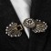 Cardigan clamp "feathers", white color in black gold