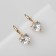 Earrings with rhinestones "Magic" hearts, white color in gold