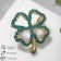 Brooch "Clover" contour, emerald color in gold