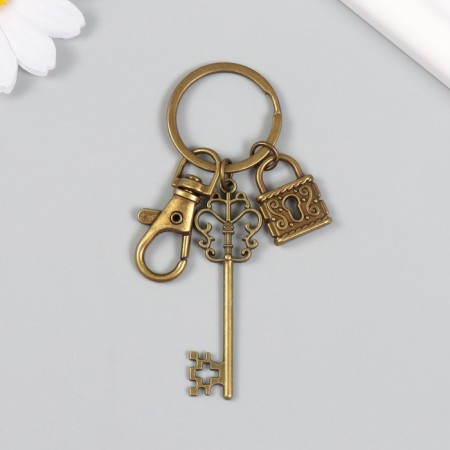A metal keychain with a carbine "openwork key and a lock" bronze 8.6 cm-2