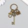 A metal keychain with a carbine "openwork key and a lock" bronze 8.6 cm