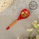 A spoon of wooden "rubella", a half -bacon, a red background