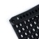 Torso key key with phone number, plastic, black