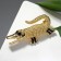 Brooch "Crocodile", black color in gold