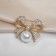 Brooch "Pearl" classic bow, white color in gold