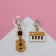 Emall earrings "Key and guitar" hanging, colored in gold