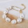 Baroque pearl bracelet with a circle, white color in gold, l = 18 cm