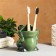 A glass under the toothbrush "Frog"