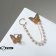 Earrings with pearls "butterfly" asymmetry, white color in gold
