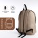 A backpack with a zipper, an outer pocket, beige color