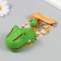 A plastic keychain with a carbine "dinosaurus-zubastik" closes when a tooth is pressed 5x7.5x4.5 cm 1049898