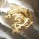 Brooch "Cosmos", white color in matte gold