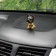 Dog on a car panel shocking his head, German shepherd