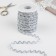 The braid of the finishing “Blutchik” with a silver thread, 5 mm, 27 ± 1 m, white color