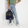 Backpack school textile art, with an overflowing patch, the color of the dark blue