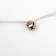 A teaser-piece with a wicker ball and colored feathers on a wooden handle, blue