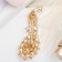 Brooch "Peacock" with a pearl tail, colored in gold