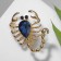 Brooch "Scorpio" drop, black and blue color in gold