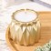 A candle in a candlelight made of gypsum with sharp faces of 10.5x8.5 cm, gold