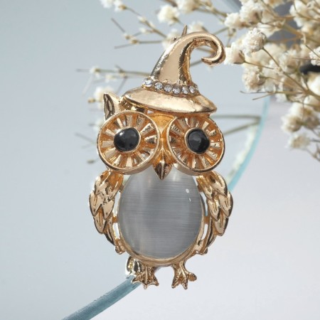 Brooch "Eagle" in a cap, black and white color in gold