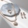 Set 3 objects: earrings, necklaces, ring "Izd" flower in geometry, white color in gold