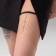 Erotic accessory on the thigh with rhinestones, golden