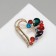 Brooch "Heart" in stones, colored in gold